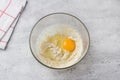 Glass bowl with dough on a gray background. Cooking greek easter orange sesame koulourakia cookies step by step