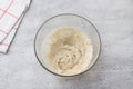 Glass bowl with dough on a gray background. Cooking greek easter orange sesame koulourakia cookies step by step