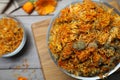 Glass bowl with dry calendula flowers on wooden table, top view. Space for text Royalty Free Stock Photo