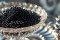 A glass bowl filled with black beads adds a touch of modern simplicity and elegance to any table, A close-up view of luxurious