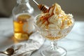 A glass bowl filled with delicious ice cream scoops and drizzled with golden honey, tempting your tastebuds, Simple honey sundae Royalty Free Stock Photo