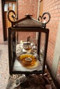 A glass bowl filled with oil and a candle sits inside a glass memorial at a Jewish gravesite in Jerusalem Royalty Free Stock Photo