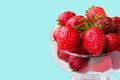 Glass bowl with fresh ripe strawberries, space for text, copy space isolated on blue background, layout, clipping Royalty Free Stock Photo