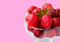 Glass bowl with fresh ripe strawberries, space for text, copy space isolated on pink background, layout, clipping Royalty Free Stock Photo