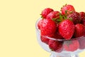 Glass bowl with fresh ripe strawberries, space for text, copy space isolated on yellow background, layout, clipping Royalty Free Stock Photo