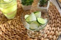 Glass bowl with frozen cucumber slices on wicker mat Royalty Free Stock Photo