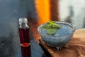 Glass bowl full of soaked sabja seeds or falooda seeds or sweet basil seeds with its extracted essence or essential oil in a trans