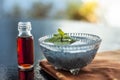 Glass bowl full of soaked sabja seeds or falooda seeds or sweet basil seeds with its extracted essence or essential oil in a trans