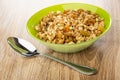 Glass bowl with granola, spoon on table Royalty Free Stock Photo