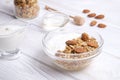 Glass bowl with Greek yogurt and mixed nuts. Healthy sports vegetarian protein rich diet, homemade granola breakfast with milk, ho Royalty Free Stock Photo