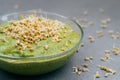 Glass bowl of green fresh smoothie made of organic vegetables with sprouted buckwheat. Healthy clean eating food concept. Raw Royalty Free Stock Photo