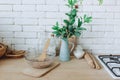 Glass bowl with groats and various kitchen utensils and dishware on wooden table