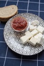 Glass bowl with homemade tomato sauce. Slices of wholemeal bread and white cheese. Close up Royalty Free Stock Photo