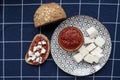 Glass bowl with homemade tomato sauce. Slices of wholemeal bread and white cheese. Close up Royalty Free Stock Photo