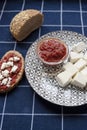 Glass bowl with homemade tomato sauce. Slices of wholemeal bread and white cheese.Close up. Royalty Free Stock Photo