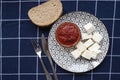 Glass bowl with homemade tomato sauce. Slices of wholemeal bread and white cheese. Top view Royalty Free Stock Photo