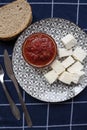 Glass bowl with homemade tomato sauce. Slices of wholemeal bread and white cheese. Top view Royalty Free Stock Photo