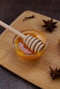 Glass bowl of honey with wooden dipper and anise Royalty Free Stock Photo
