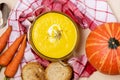 Glass Bowl of Hot and Tasty Pumpkin or Carrots Soup Ripe Pumpkin and Carrots Napkin Top View Flat Lay Healthy Autumn Food