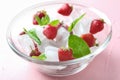 Glass bowl with ice cubes and strawberries on color background Royalty Free Stock Photo