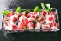 Glass bowl with ice cubes and strawberries on table Royalty Free Stock Photo