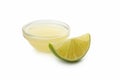 Glass bowl with lime juice and slice isolated on white background Royalty Free Stock Photo