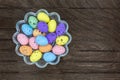 Glass bowl with many colorful Easter eggs taken from top with dark wooden background to Easter and copy space on the right side Royalty Free Stock Photo