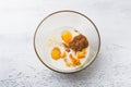 Glass bowl with milk, eggs, pumpkin puree, spices on a light blue table, top view. Stage of preparing homemade pumpkin Royalty Free Stock Photo