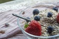 Glass bowl with old teaspoon, cereals, strawberries Royalty Free Stock Photo