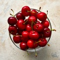 Glass bowl with ripe cherries on a textured background. Top view. Royalty Free Stock Photo