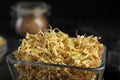 Glass bowl of sprouted green buckwheat on table, closeup