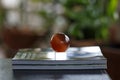 Glass ball on a stack of magazines