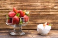 Glass bowl with strawberries and cream on a table near Royalty Free Stock Photo