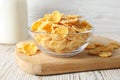 Glass bowl of tasty crispy corn flakes on white wooden table Royalty Free Stock Photo