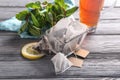 Glass bowl with tea bags on wooden table Royalty Free Stock Photo