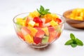 glass bowl with tropical fruit salad on a white surface Royalty Free Stock Photo