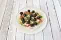 Glass bowl with Turkish salad of black olives, peppers, tomatoes and chopped Royalty Free Stock Photo