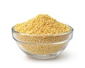 Glass bowl of uncooked yellow millet grains