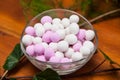 Glass bowl with white and pink sugared almonds