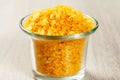 Spa nature products. Glass bowl with yellow sea salt for bathroom procedures Royalty Free Stock Photo