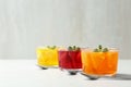 Glass bowls of natural jelly desserts on light table