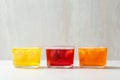 Glass bowls of natural jelly desserts on light table