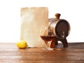 Glass of brandy, barrel, old paper on a white background Royalty Free Stock Photo