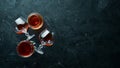 A glass of brandy on a black background. Top view. Royalty Free Stock Photo