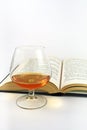 Glass of brandy and book