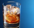 Glass of brandy with ice cubes Royalty Free Stock Photo