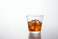 Glass of brandy and ice cubes on background Royalty Free Stock Photo