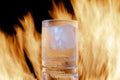 glass of brandy with ice on fire on a black background Royalty Free Stock Photo
