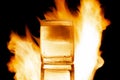 glass of brandy with ice on fire on a black background Royalty Free Stock Photo
