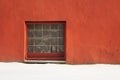 Glass brick square window in red plastered wall with copyspace